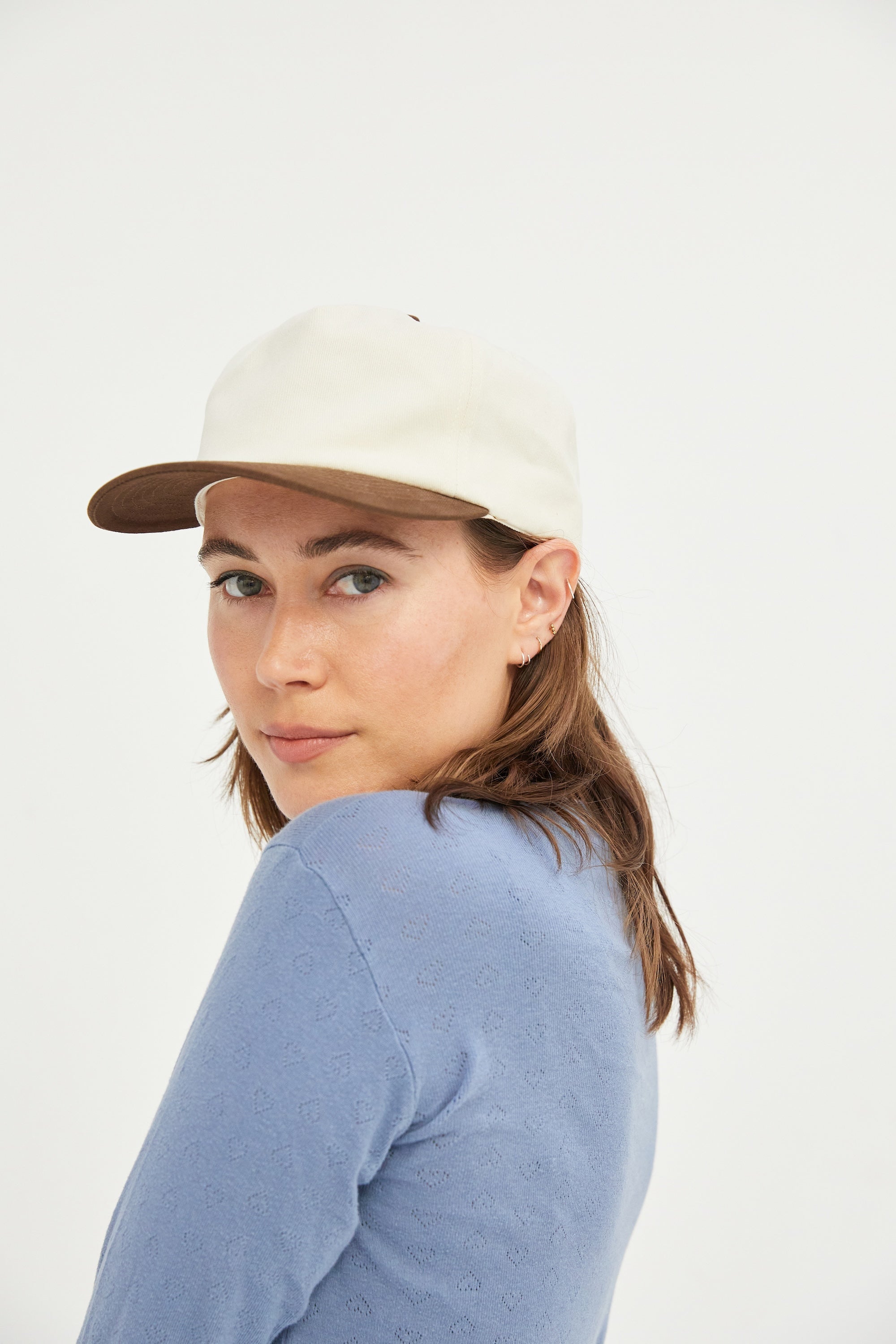 Female model wearing a WELD MFG Two-Tone Brushed Cotton Twill Workhorse Snapback Hat with a slightly structured 5-panel crown and contrasting curved brim, Java